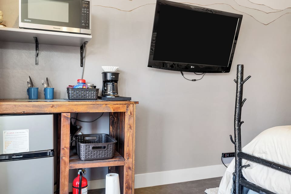 Kitchenette with mini fridge, microwave, and complimentary snacks/coffee