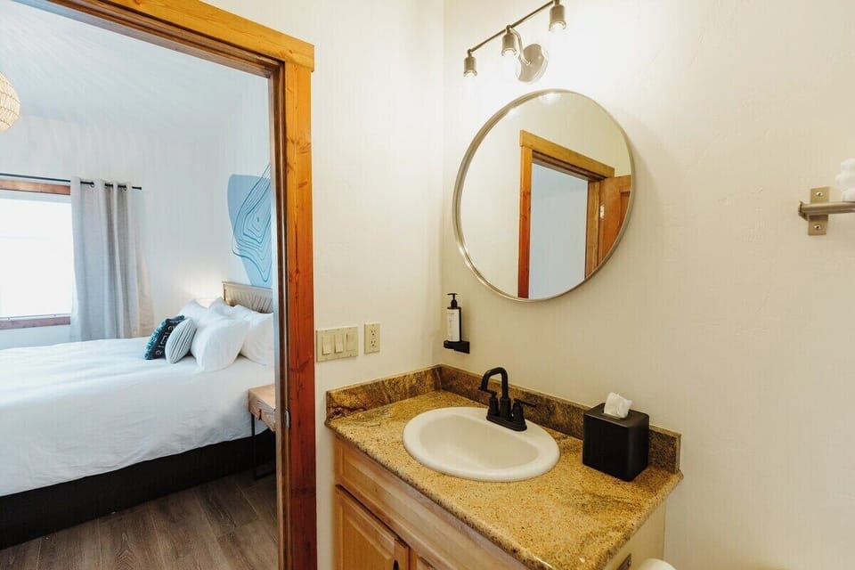 [Bathroom] A private bathroom with a shower/tub combo is accessed through the bedroom.