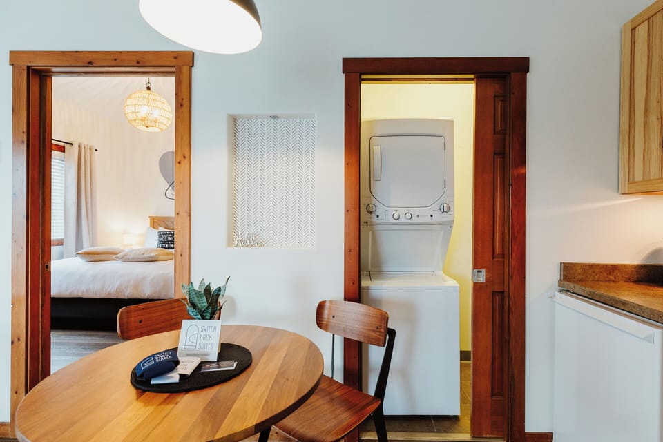 [Laundry area] Your suite includes a private washer and dryer, so you can conveniently do laundry in your unit. We include complimentary laundry pods.