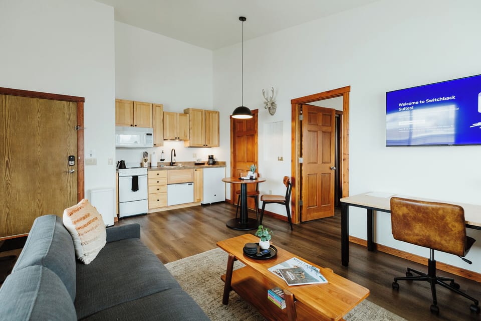 [Living area] Our suite features an open floor plan, and large windows create a bright and inviting vibe so you feel comfortable and right at home.
