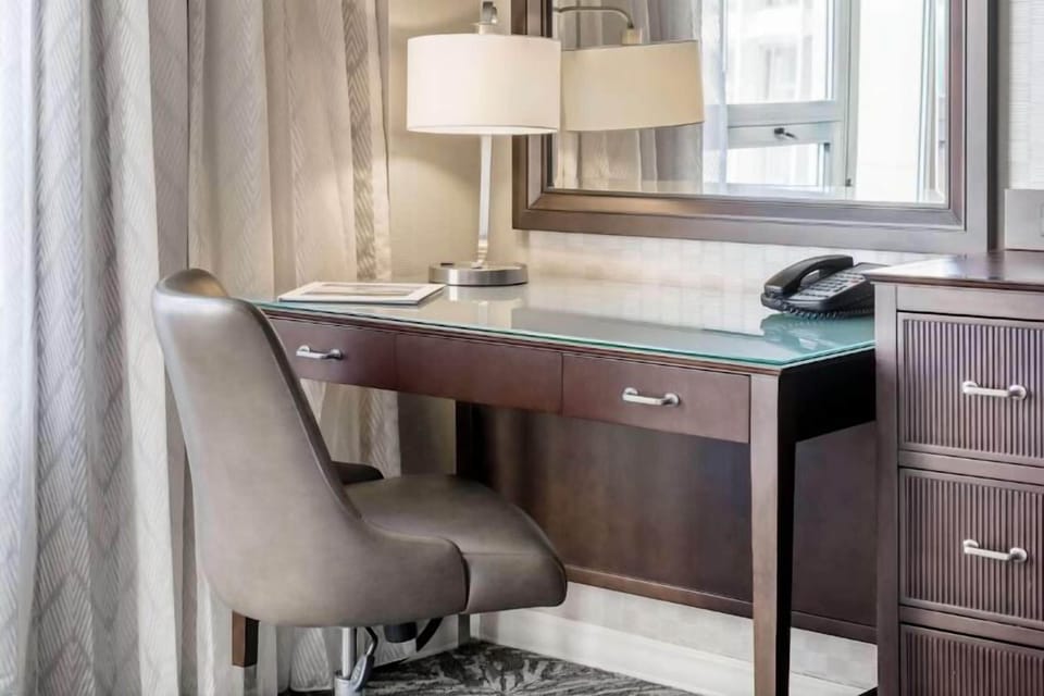 Catch up on emails at a sleek, well-lit workspace.