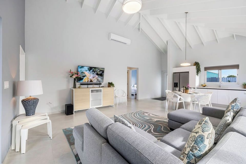 This bathroom comes with complete amenities, a toilet, and a shower with a glass partition.
