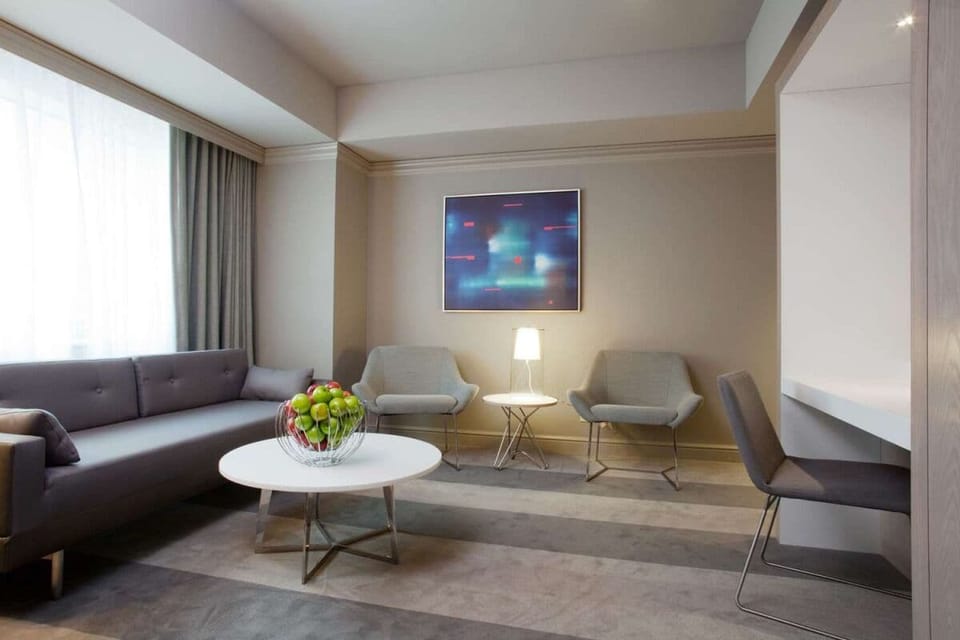 Relax together in a sunlit sitting area with modern style.