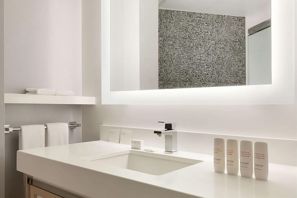 Refresh at a spa-clean vanity with bright mirror lighting.