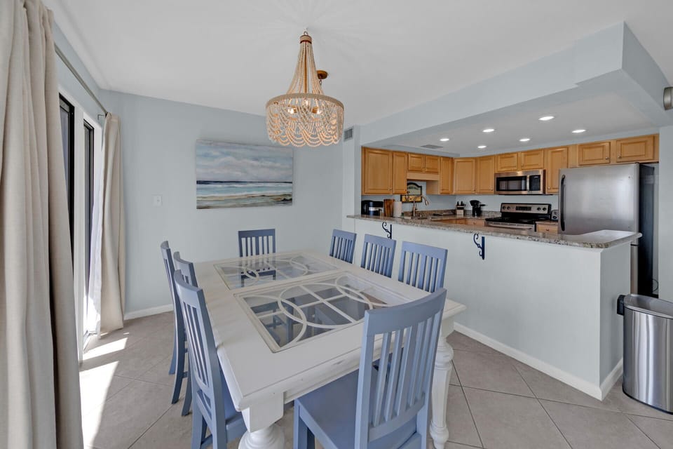 Dining area with access to kitchen and private balcony with stunning Gulf views
