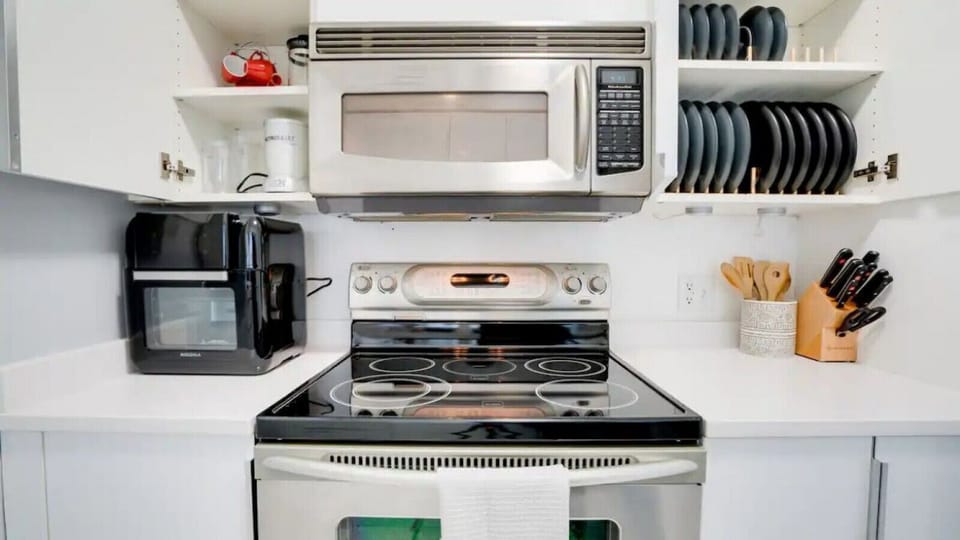 Kitchen equipped with quality appliances, cookware, and utensils