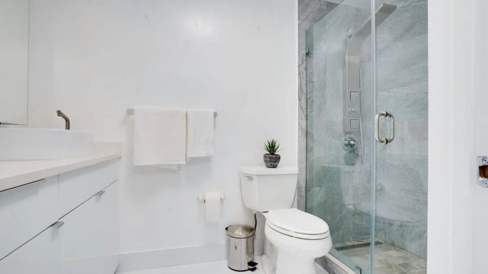 Spacious bathroom complete with sink, toilet, and shower