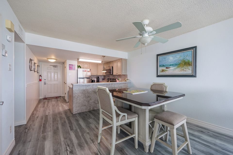 Step into your bright, modern kitchen and dining space where coastal charm meets convenience for your perfect getaway meals.