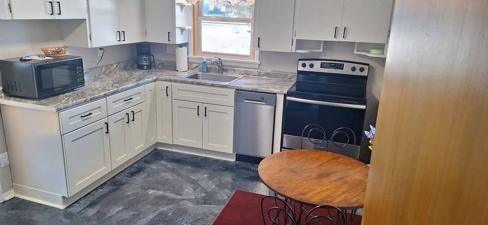 Modern, fully stocked kitchen with stainless steel appliances.