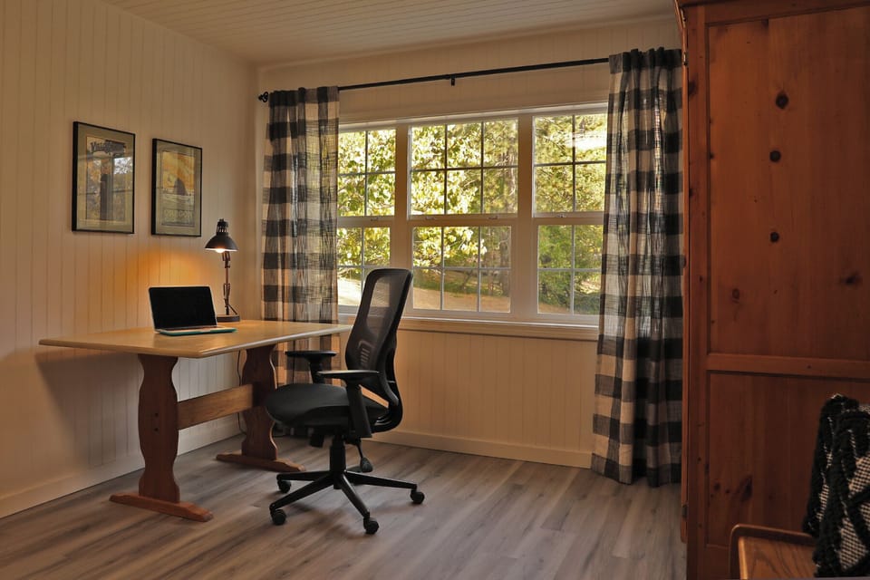 Work from home office with lamp, ergonomic chair and a door for privacy. 