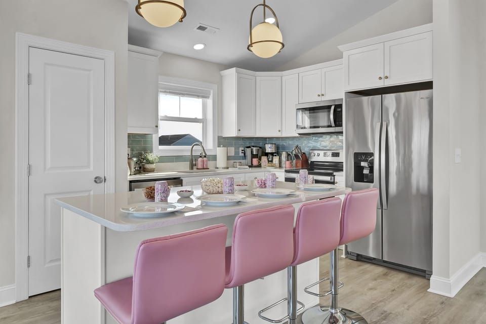 Cook, dine, and connect in the fully stocked kitchen, complete with modern appliances and bar seating for four.