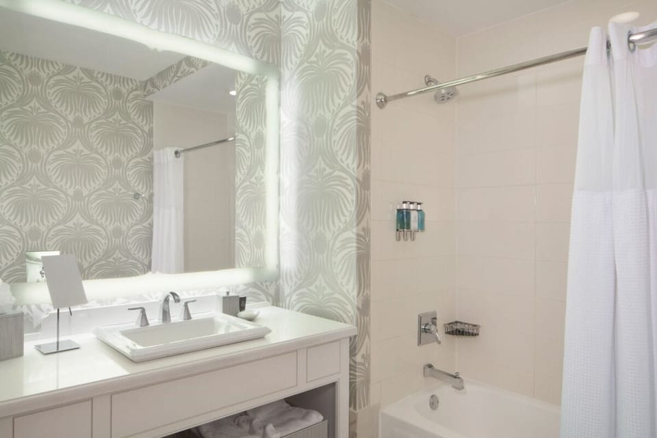 Refresh under a soothing shower beside a bright, modern vanity.
