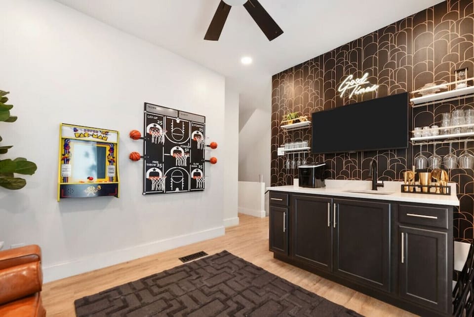 Entertainment lounge with wet bar, Smart TV, and game-ready setup