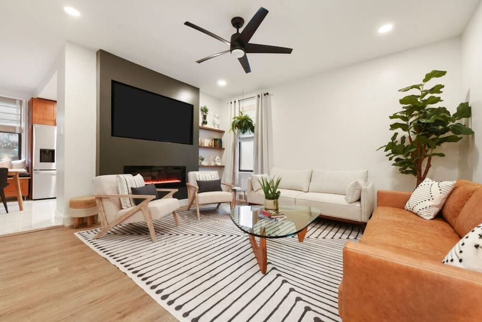 Bright, modern living room with large Smart TV and comfortable seating
