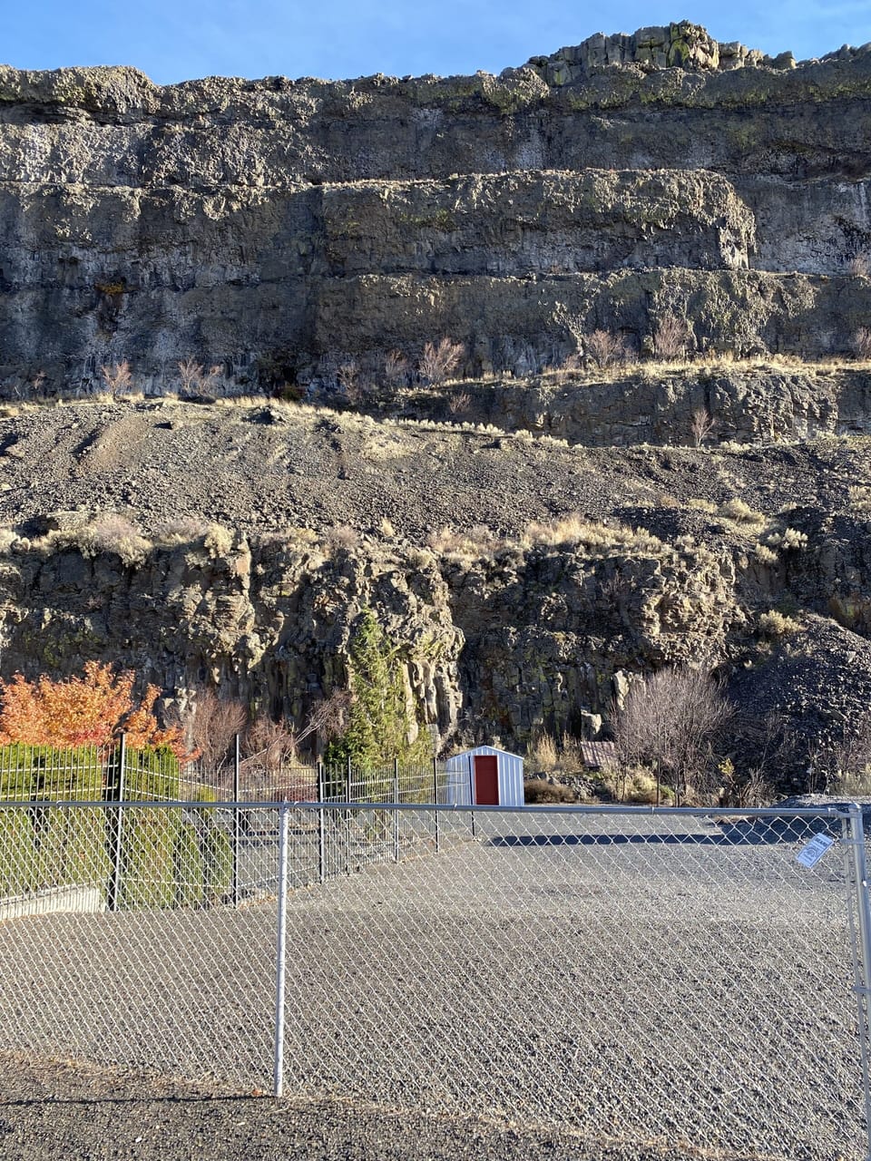 View from back of house. Parking next to fence.