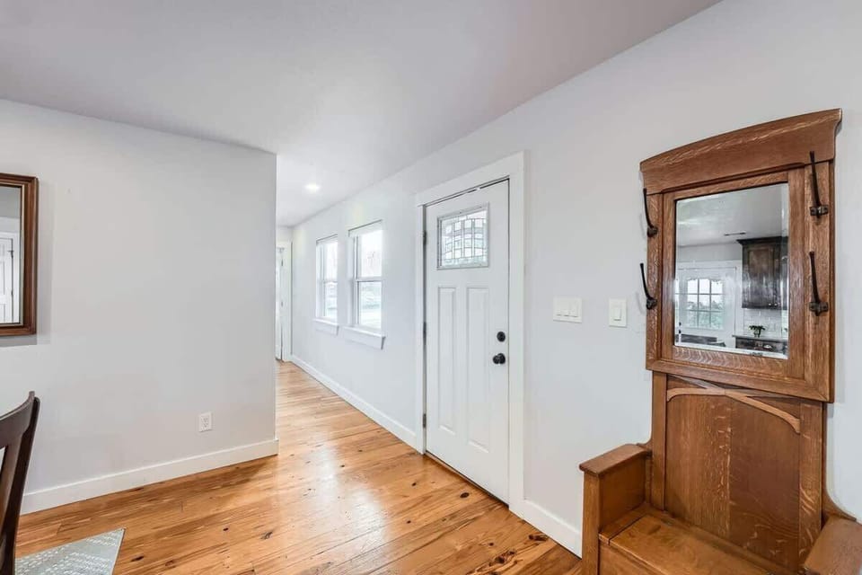 Foyer - Bright entryway with warm hardwood floors and charming vintage accents!