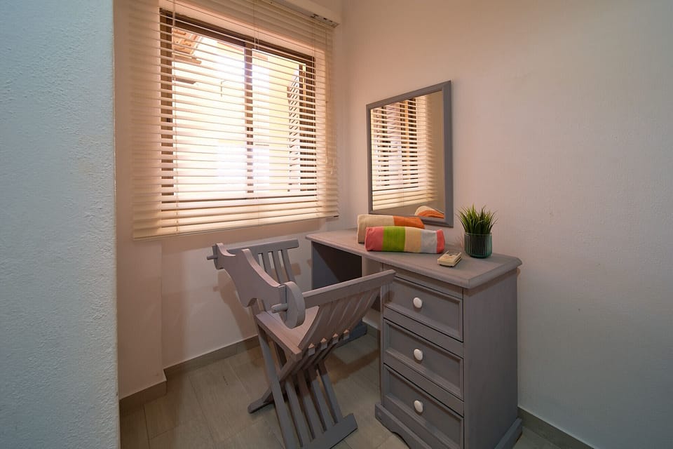 The second bedroom in Casa Leste, which is also air-conditioned, also has a dressing table.