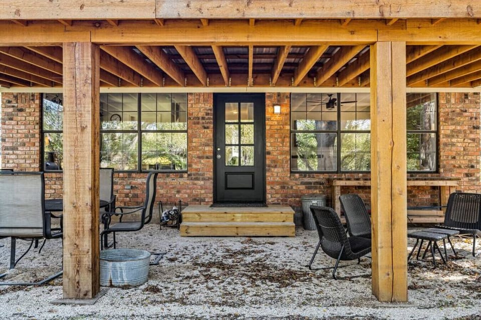Peaceful back porch overlooking the river with dining area and charcoal grill