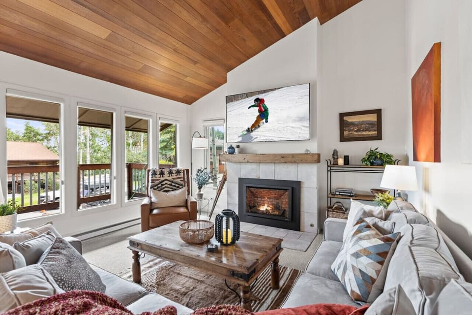 Open and spacious great room has a large sectional couch and new gas fireplace.  Enjoy lots of windows and a wrap around deck.