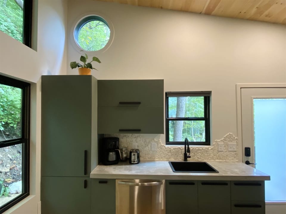 A chef’s dream—sleek counters and open shelves in a bright layout.