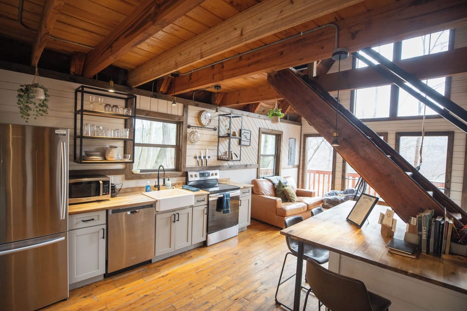 Modern cabin kitchen with stainless appliances and a breakfast bar—ideal for cooking in the Gorge.