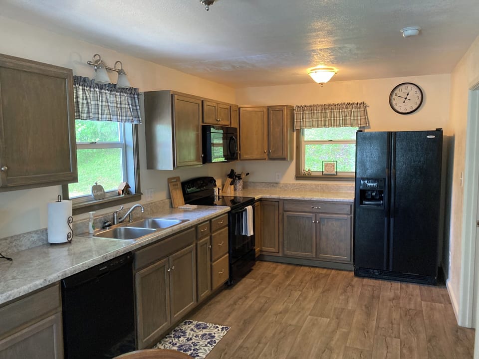Large kitchen area with dishwasher,  range, microwave and refrigerator
