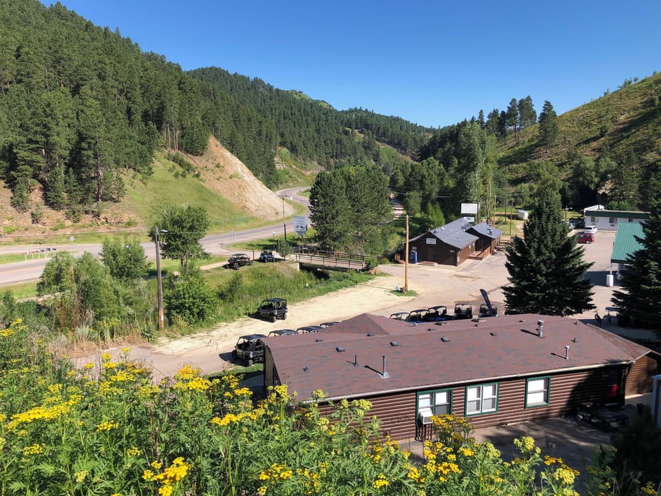 The green roof on right side of photo is Building A entrance to your room.