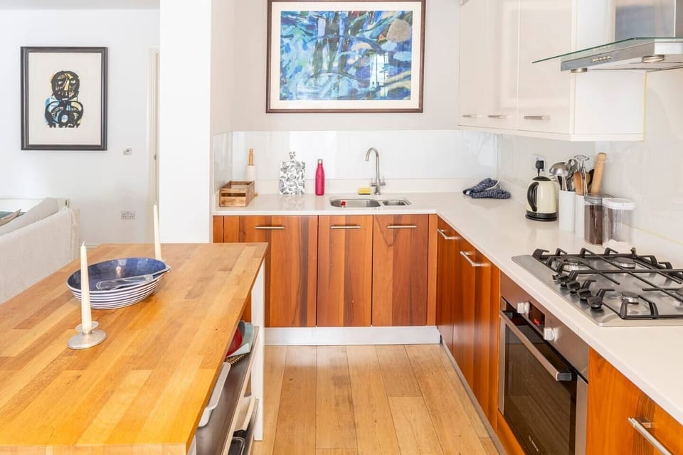 Open plan kitchen: gas hob, electric fan oven, dishwasher, fridge and freezer