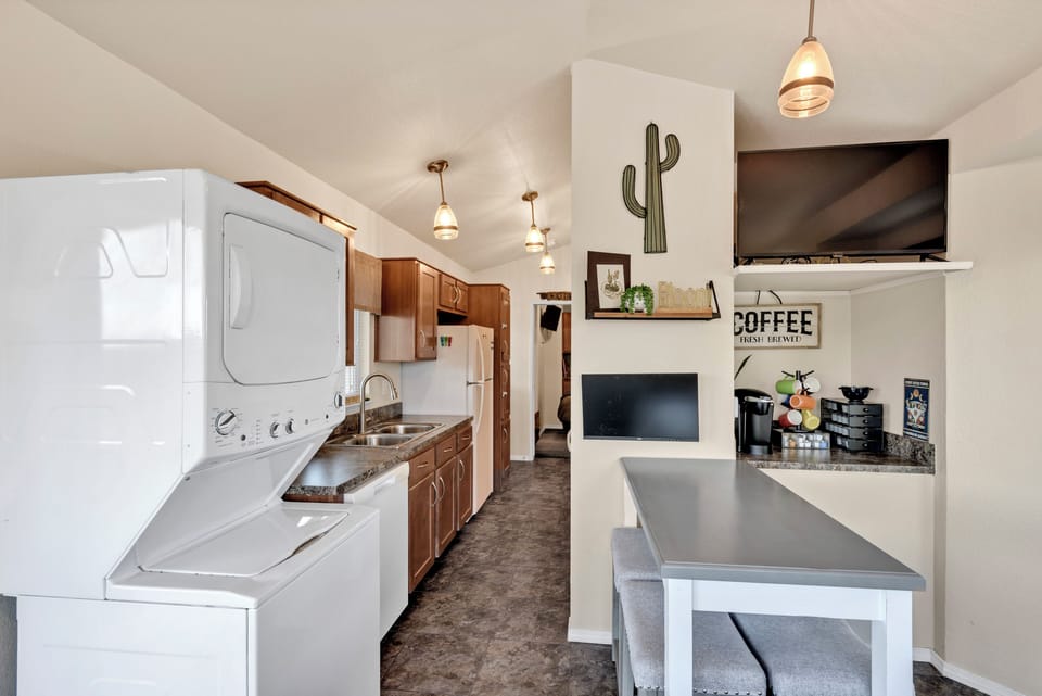 Enjoy a comfy dining area, smart TV, coffee bar, monitor, and washer/dryer.