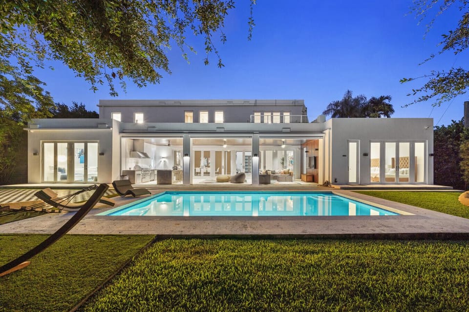 Elegant backyard featuring sparkling pool and open lounge area