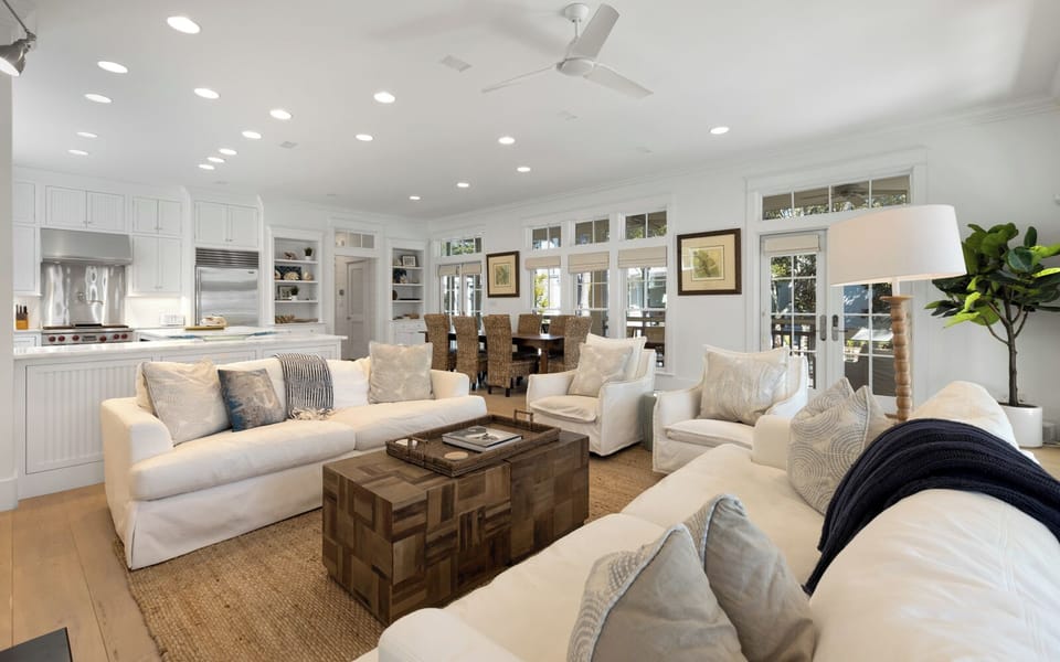 Sink into plush white sofas in your open-concept haven, where kitchen and living flow seamlessly together for perfect entertaining.