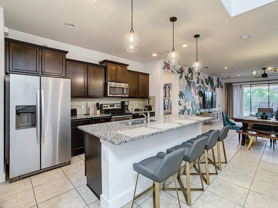 Fully equipped kitchen with a sleek countertop and bar-style seating, perfect for cooking, dining, or just hanging out.