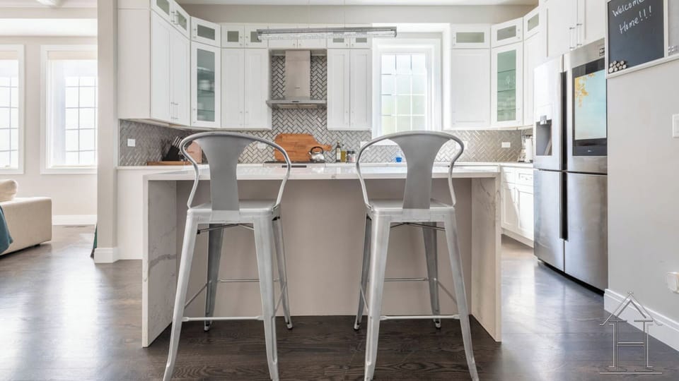 Chef's kitchen w/ large island and seating. Fully stocked.