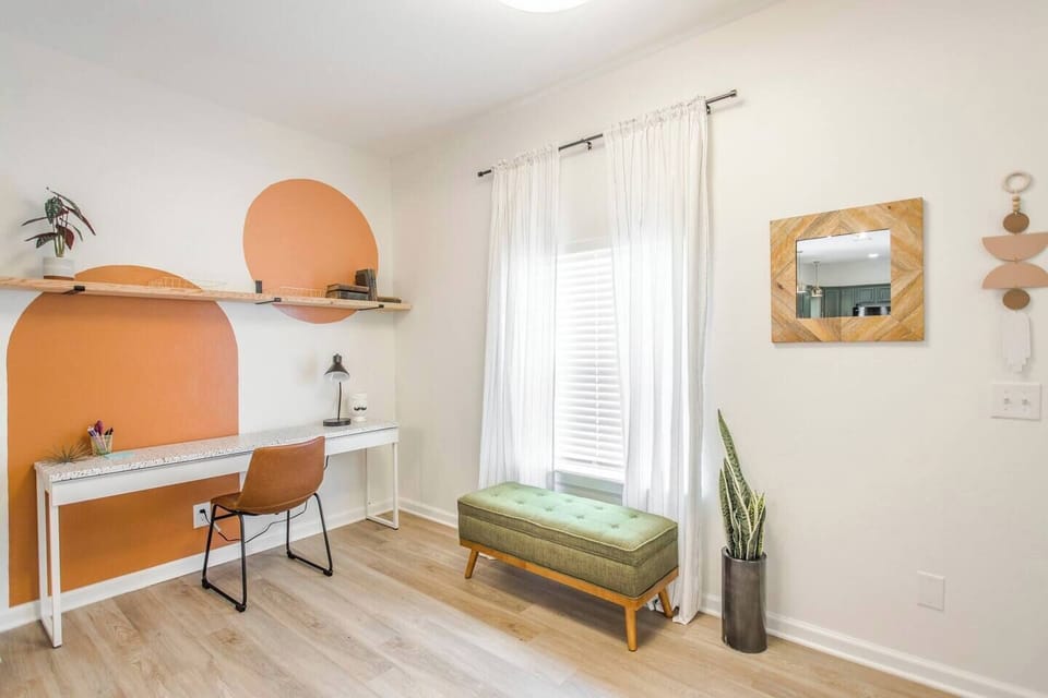 Bright and modern workspace with playful wall art, perfect for remote work or creative inspiration