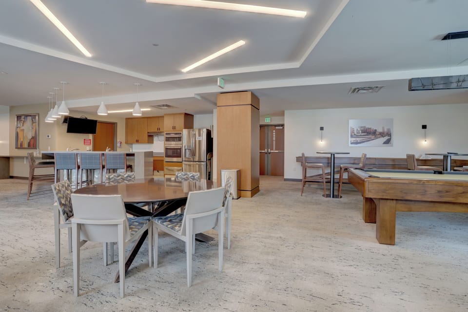 Community room  with pool table and shuffleboard.