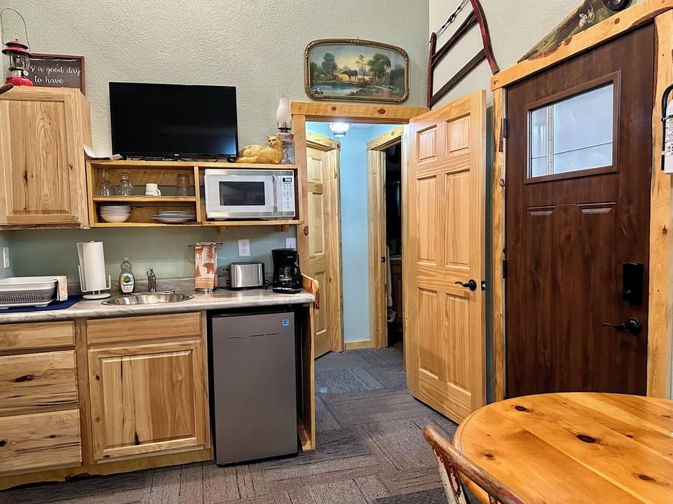 Here the bathroom foyer door is open, with bathroom inside foyer on right. 