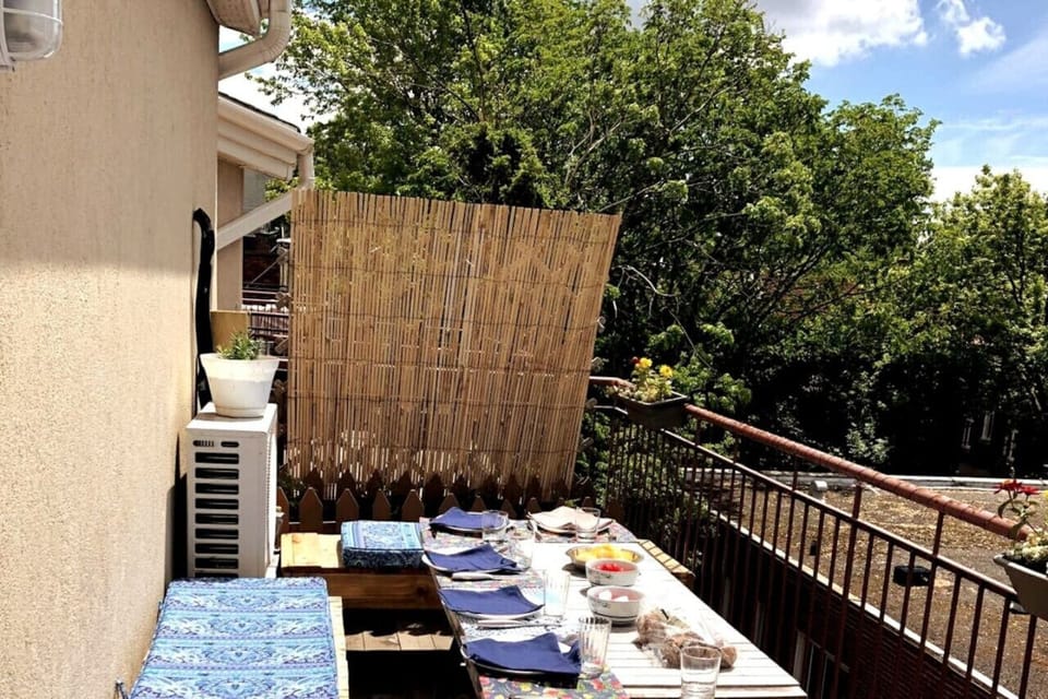 Balcony with a dining table and chairs—perfect for enjoying meals with a refreshing outdoor ambiance.