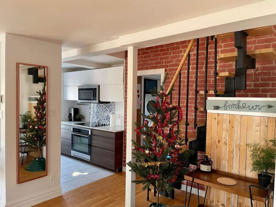 Staircase near the kitchen featuring a white and wood theme—seamlessly blending style and functionality.