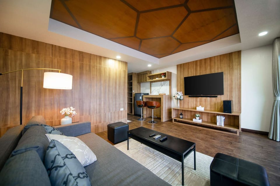 Modern third-story open-plan living with sleek wood accents, bar seating, and a private balcony overlooking Patong Bay. Relax, unwind, and enjoy the perfect blend of comfort and stunning sea views.

-House 21