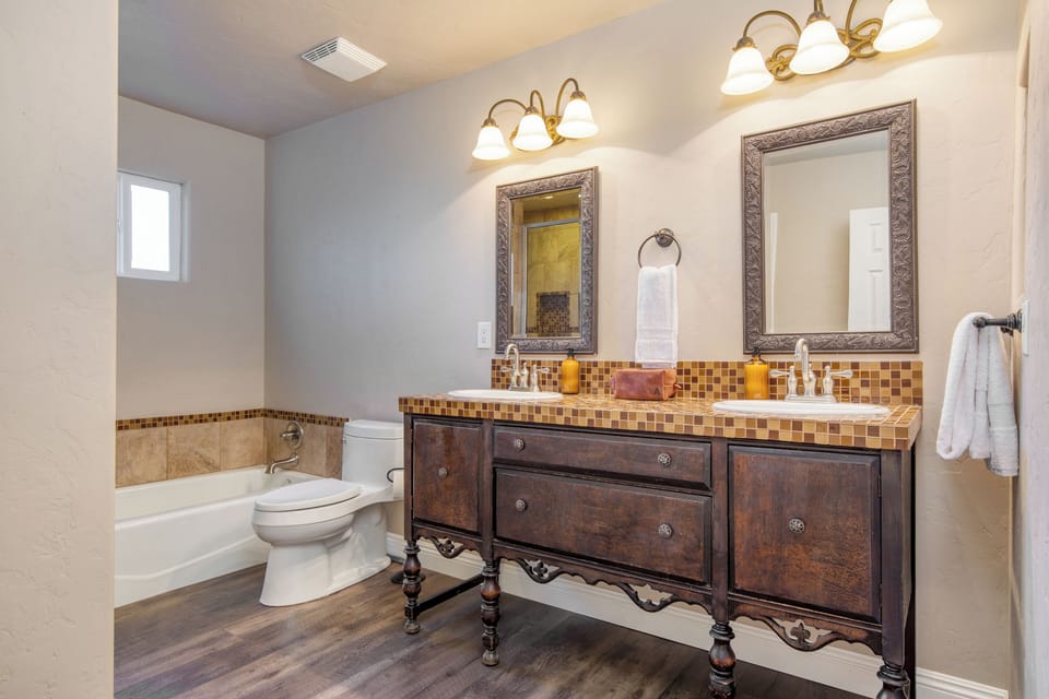 Primary bedroom's ensuite features double sinks, a bathtub, and a shower.