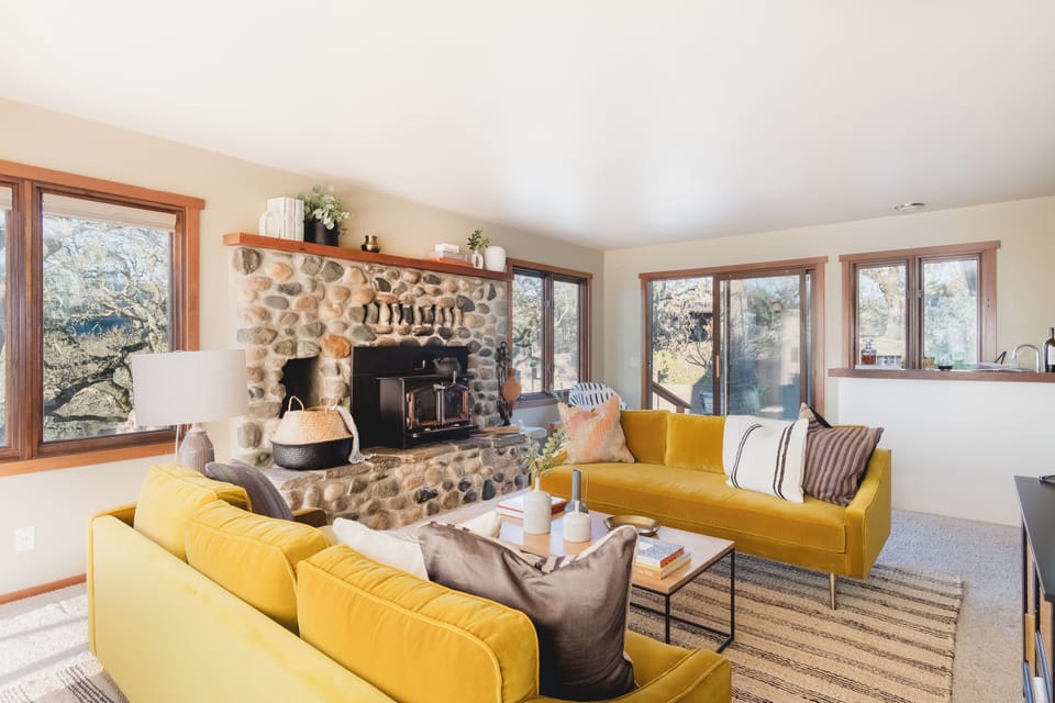 Relax in the living room surrounded by California oaks.
