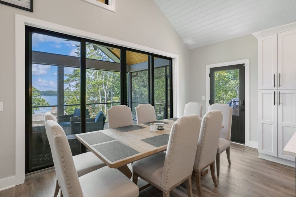 Dining table with view of lake, next to kitchen