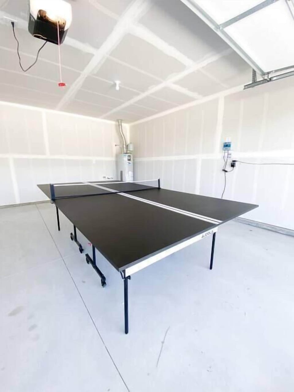 The ping pong table in the garage is all yours to use!