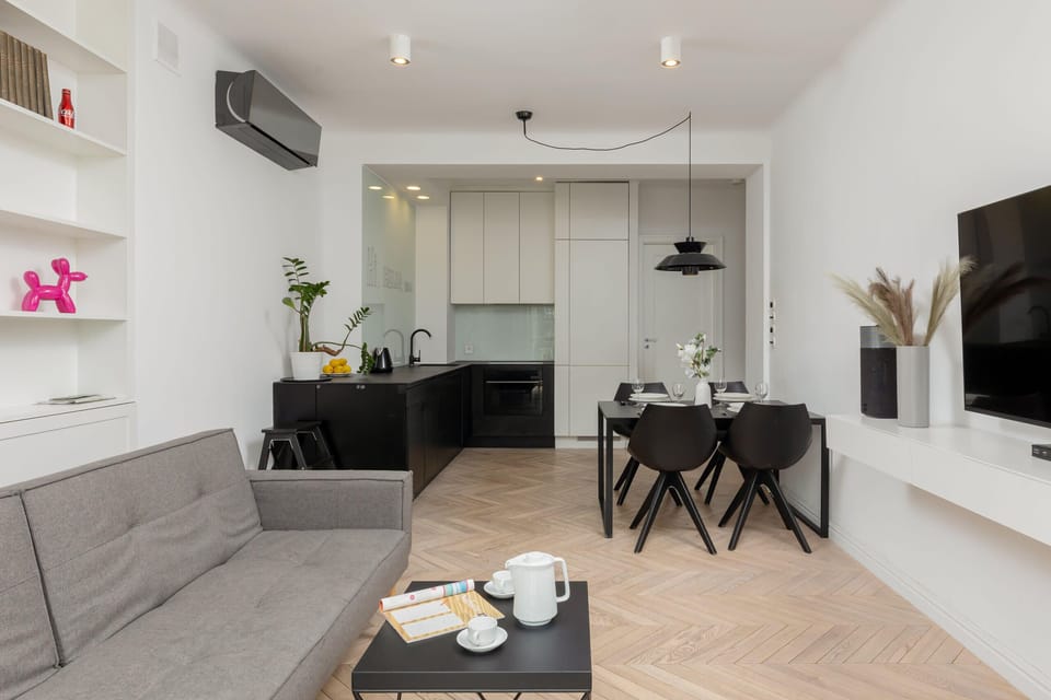 A spacious living room and dining area, blending comfort and functionality with chic decor.
