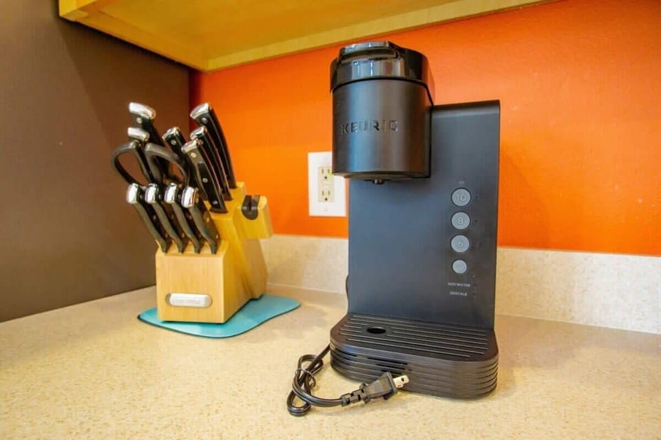 Start your day with a fresh brew from our Keurig in this vibrant kitchen corner.