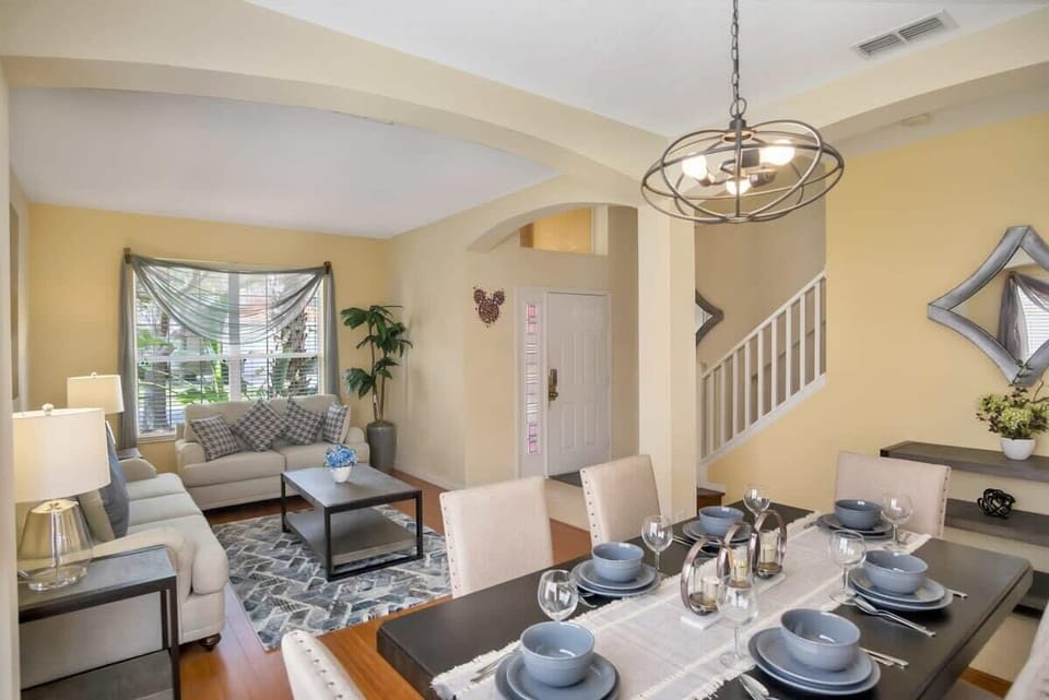 Elegant living and dining space with cozy seating and stylish decor, perfect for relaxing and entertaining.