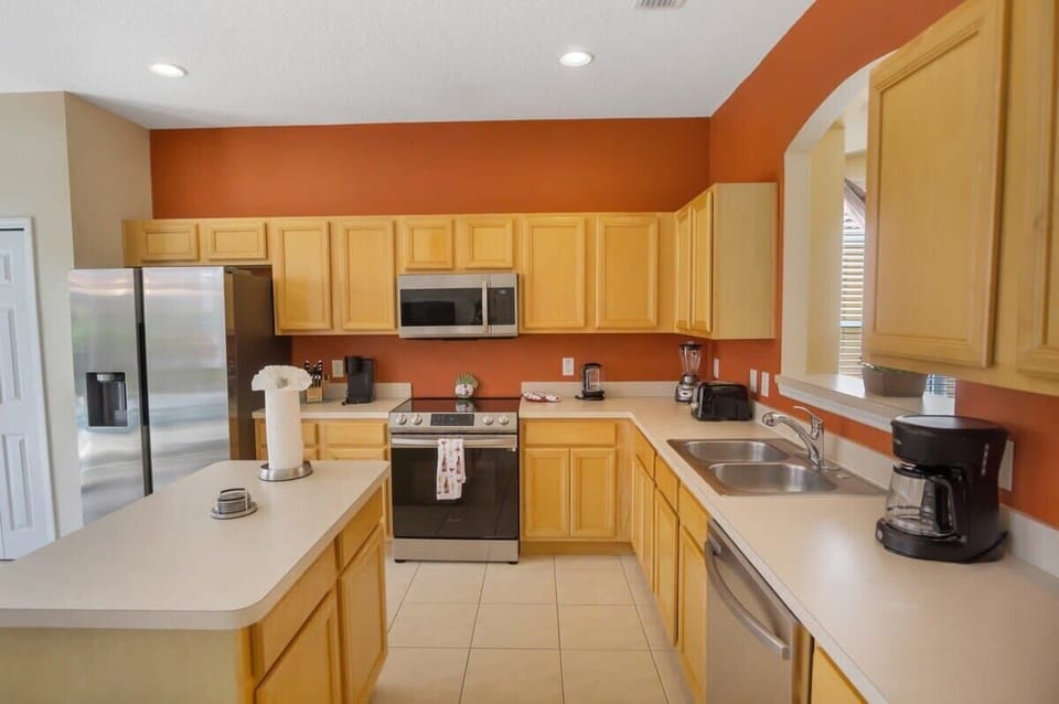 Modern kitchen with stainless steel appliances and ample counter space, perfect for culinary adventures.