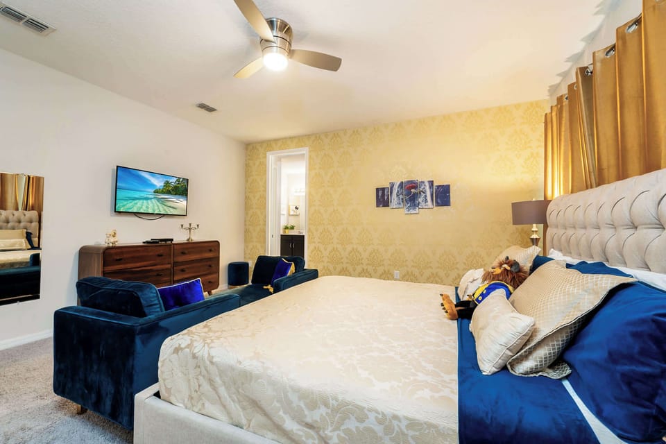 Unwind in this elegant bedroom with plush velvet seating, luxurious bedding, and a serene ambiance perfect for relaxation.
