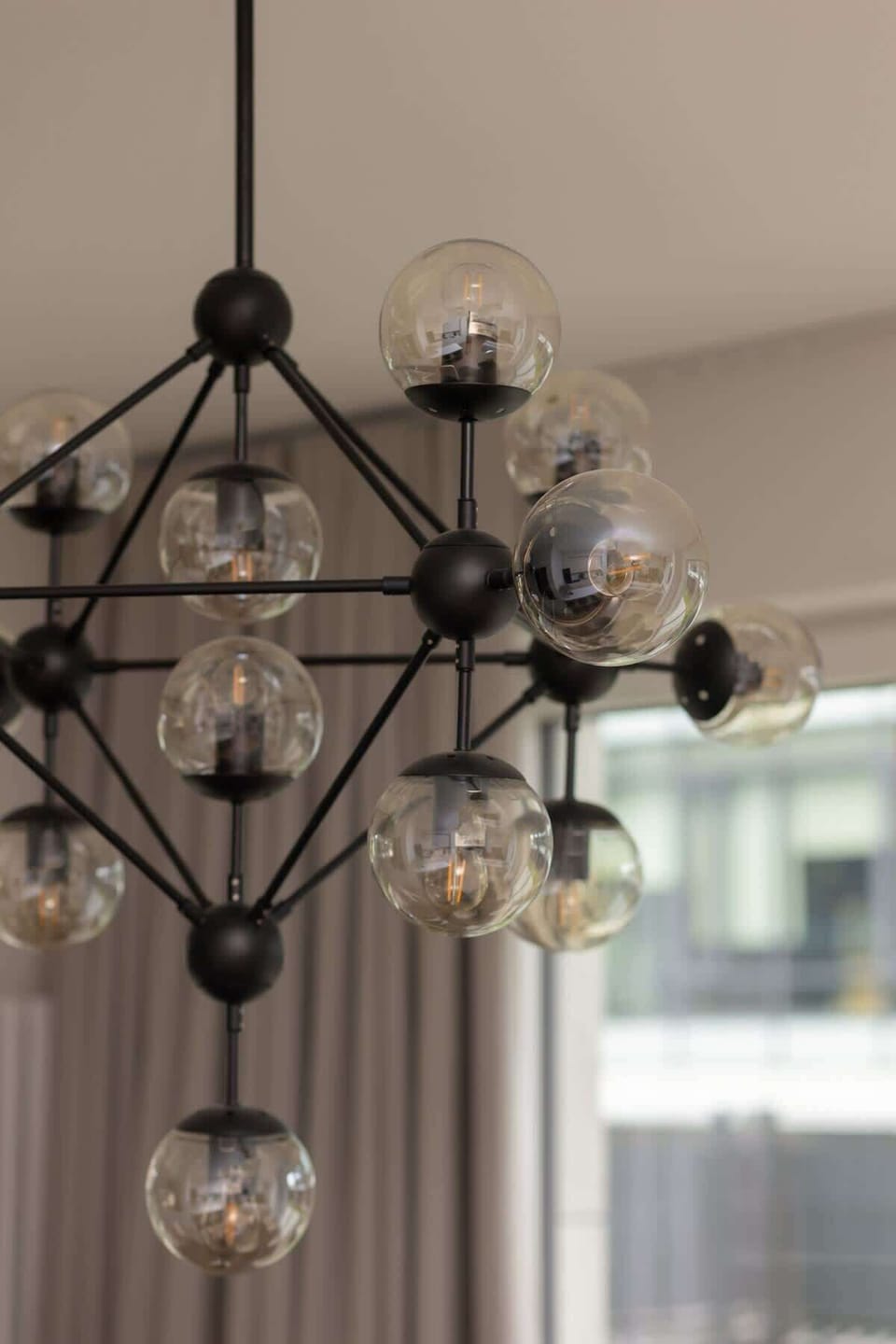 A modern chandelier hanging from the ceiling, adding elegance and symmetry.