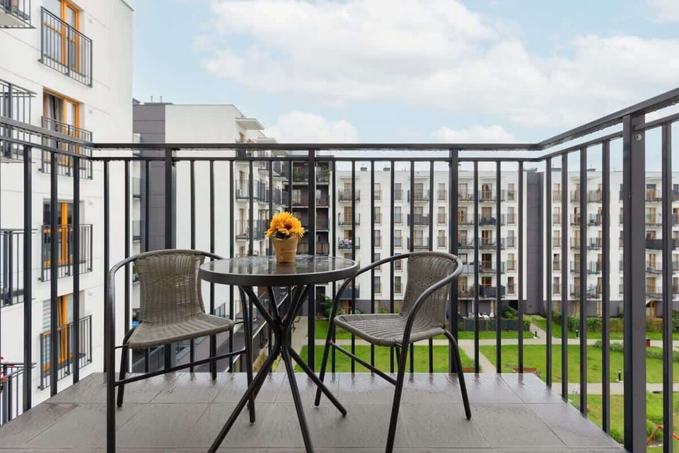 Another perspective of the balcony with a small table and chairs, ideal for outdoor relaxation.

